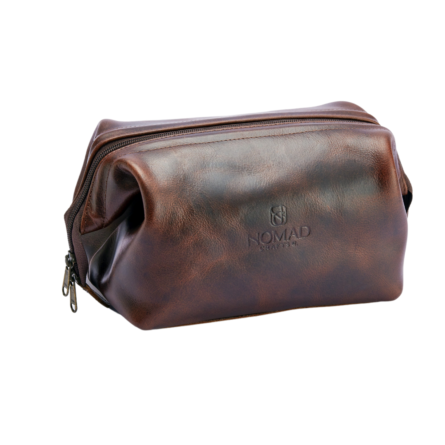 Brown leather toiletry bag with 'Nomad' branding on a white background