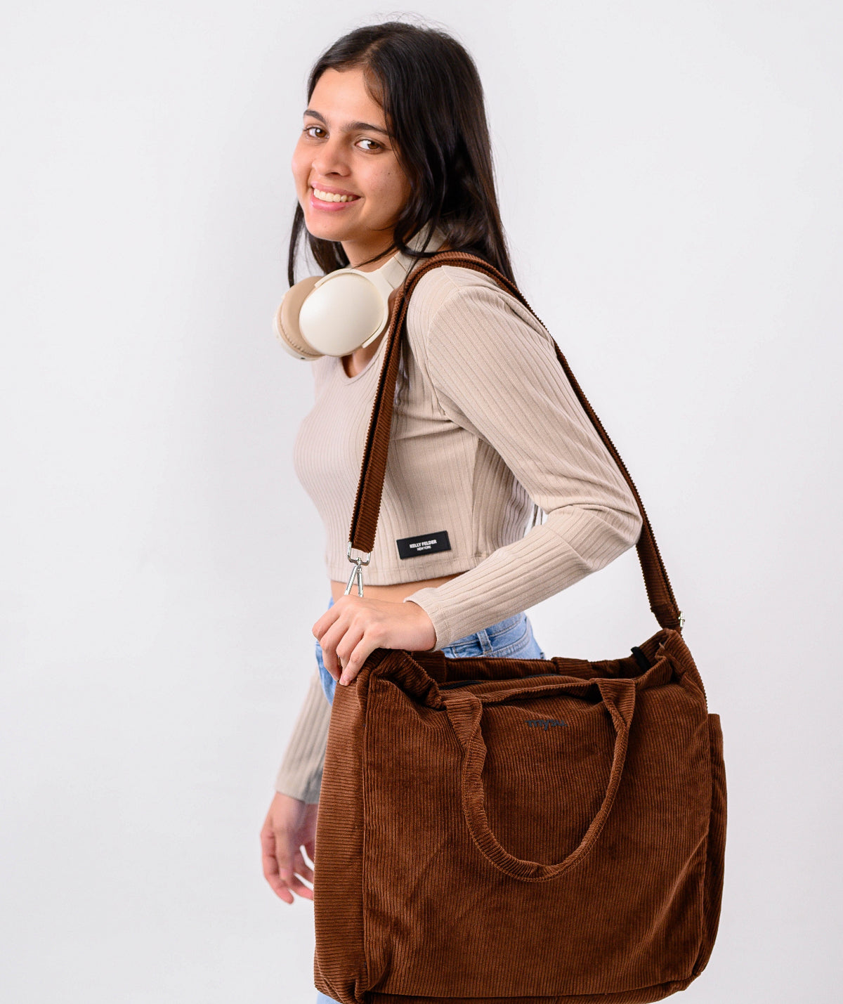 Woman holding a brown bag against a white background